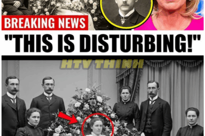 🦊 ARCHIVE NIGHTMARE: HISTORIANS DISCOVER UNSETTLING FIGURE HIDDEN IN CENTURY-OLD FUNERAL IMAGE—THE TRUTH IS DARKER THAN EXPECTED 👁️